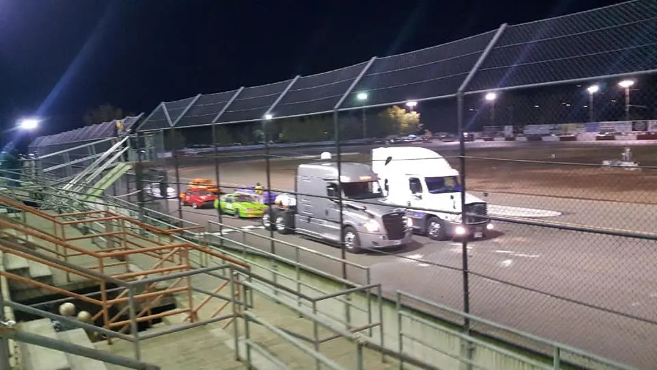 A truck and car are parked in the parking lot.